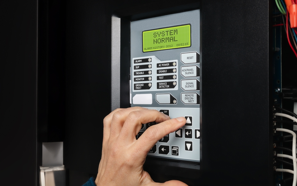 Technician,Using,Fire,Alarm,Control,Panel,In,Service,Room.,Single-stage